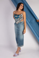 Girl in profile with a long denim skirt in faded blue