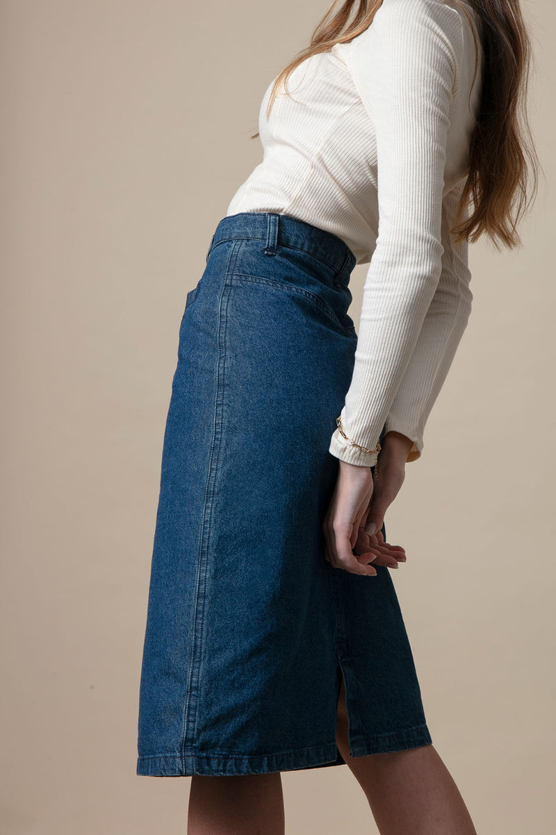 Girl wearing vintage clothing with a long denim skirt and a long sleeved top.